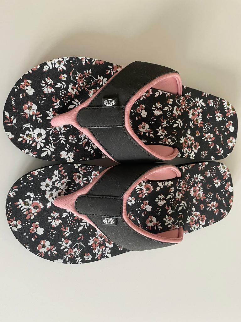 black animal flip flops